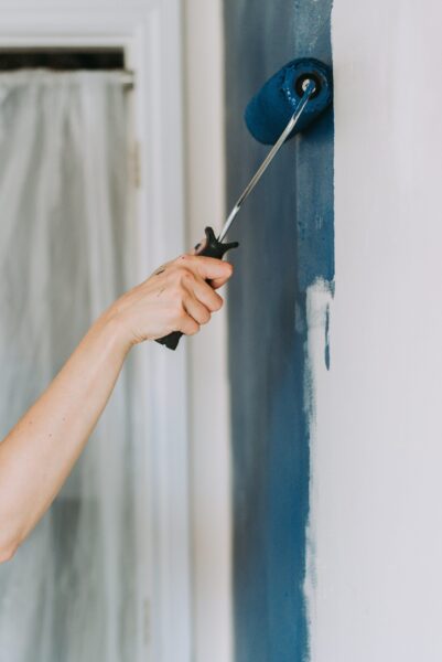 closeup shot person using paint rollers with color blue scaled e1727583411965