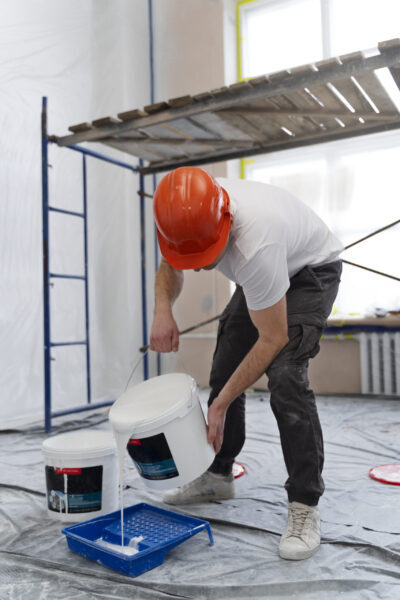 full shot man pouring paint scaled e1727583221307