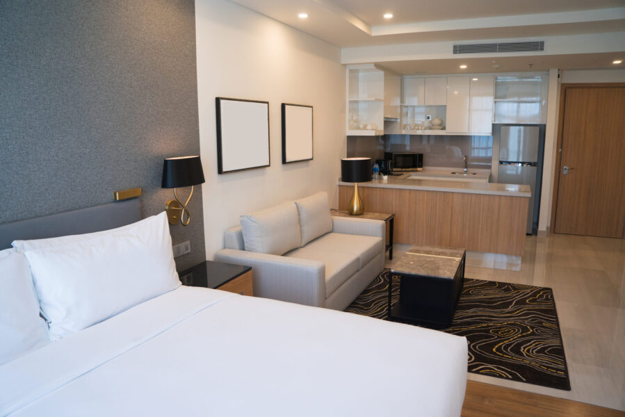 hotel room interior with bedroom area living space kitchen scaled e1727585616726
